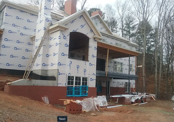 A house with trees in the background
Description automatically generated